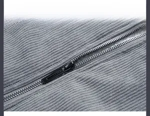 Close-up of premium black metal zipper on grey corduroy jacket with ribbed texture
