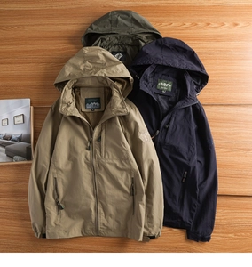 Outdoor hooded jackets in khaki, navy, and green colors displayed on wooden background