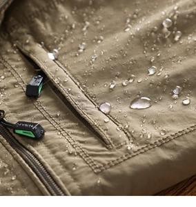 Macro shot of water-repellent khaki fabric and zipper detail on men's outdoor jacket