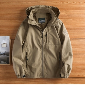 Detail view of khaki outdoor jacket showing the adjustable hood and inner size M label