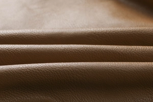 Close-up of brown PU jacket showing the premium lychee texture and thick material