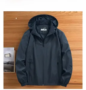 Detail view of navy blue outdoor jacket featuring adjustable hood and elastic cuffs