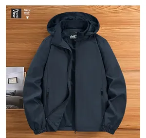 Flat lay of navy blue men's windbreaker jacket with detachable hood on wooden surface