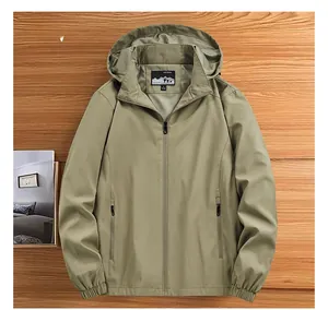 Detail view of khaki hooded outdoor jacket featuring drawstring hood and zipper pockets