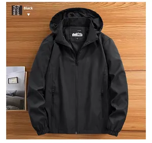 Detail of windproof men's jacket with hood, elastic cuffs, and outdoor brand label