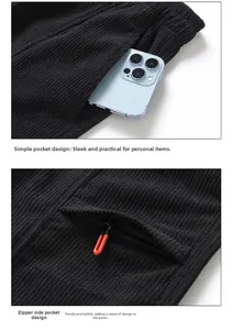 Detail view of black corduroy shorts showing side pocket and secure zipper with red puller