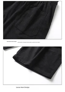Detailed close-up of corduroy texture, rear pocket design, and loose hem on black shorts