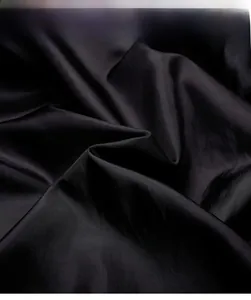 Close-up of premium breathable black faux leather fabric with soft skin-friendly texture