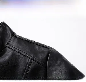 Detailed close-up of the structured shoulder design on a black leather jacket