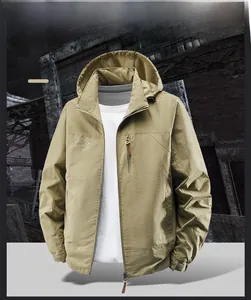 Detail of khaki outdoor hooded jacket featuring front embroidery and zip pockets