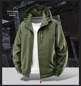 Close-up of green outdoor jacket featuring waterproof zipper pocket and mesh lined hood