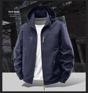Detail view of navy blue outdoor jacket featuring waterproof zipper pocket and logo embroidery