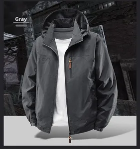 Macro detail of men's gray outdoor jacket featuring zippered chest pocket and logo