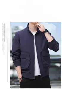 Detail of navy outdoor jacket with utility chest pockets and standing collar design