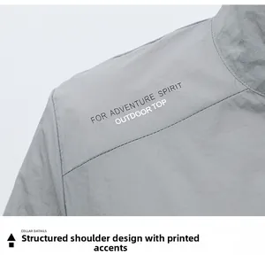 Close-up of gray sun protection jacket with outdoor adventure spirit shoulder print