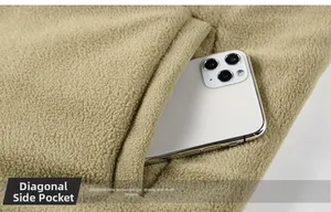 Detailed macro view of deep side pocket on khaki fleece vest with smartphone reference