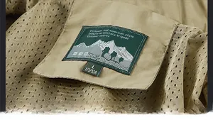 Close-up of khaki jacket collar with breathable mesh lining and brand size label
