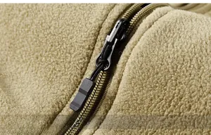 Detailed macro view of durable metal zipper and thick fleece fabric on outdoor vest