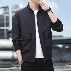 Close-up of black hiking jacket featuring stand collar and large cargo pockets with X-stitching