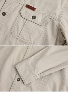 Detail of khaki cotton work shirt with outdoor leather patch and reinforced stitching