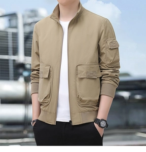 Detail of khaki outdoor tactical jacket featuring multiple utility pockets and ribbed cuffs
