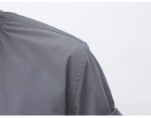 Close-up of durable shoulder stitching and premium gray synthetic fabric on outdoor jacket