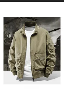 Detail of khaki bomber jacket featuring utility pockets and metallic zipper closure