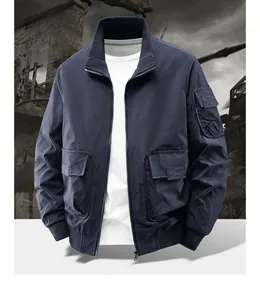 Detail of blue bomber jacket showing utility sleeve pocket and tactical metal zipper