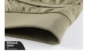 Detailed macro view of the ribbed hem on a khaki flight jacket showing high fabric density