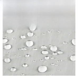 Close-up of water-repellent UPF50+ fabric showing lotus effect with water droplets