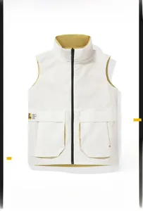 Detail view of white vest featuring utility pockets and contrasting yellow lining with zipper