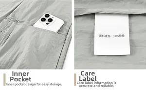 Detail of grey lightweight nylon jacket showing inner storage pocket with phone and wash label
