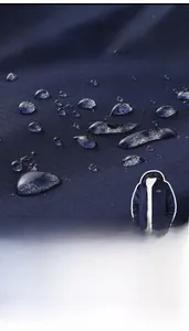 Detailed views of waterproof fabric and adjustable cuffs on the navy outdoor jacket