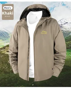 Detail of khaki windproof outdoor jacket with embroidered mountain logo on chest