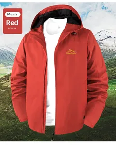 Detail of red hooded outdoor jacket for men with embroidered mountain logo and waterproof fabric