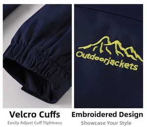 Close-up of adjustable velcro cuffs and mountain embroidery on a waterproof outdoor jacket