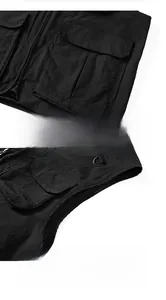 Detail of multi-pocket tactical vest showing utility D-ring and durable stitching