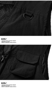Detail of outdoor fishing vest showing D-ring hook, mesh lining, and ripstop fabric texture