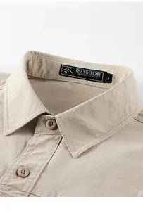 Detail of outdoor shirt collar showing double-stitched seams and beige texture
