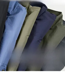 Detail shot of multi-color lightweight windbreaker fabrics showing textured ripstop pattern