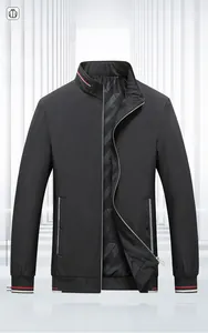 Detail of stand collar business jacket with red and white striped ribbing and zipper