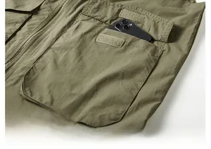 Detail shot of army green outdoor vest featuring large flap pocket and velcro closure
