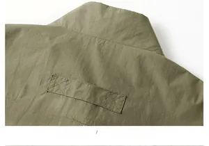 Macro detail of military green quick-dry vest back collar with reinforced stitching