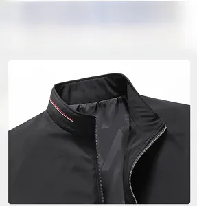 Detail of men's black stand collar jacket featuring red and white stripe trim and zipper