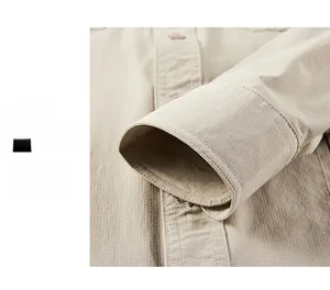 Detail showing khaki shirt cuffs with vertical texture and double stitching design