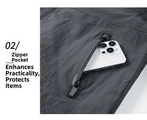 Detail of deep grey outdoor jacket showing a secure zippered pocket with large storage space