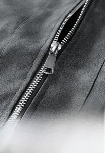 Detail of dark gray jacket featuring metallic zipper pull and elasticated cuffs texture