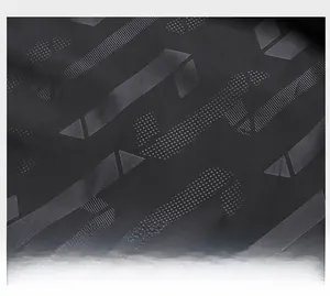 Detailed macro view of dark grey high-density jacquard fabric with geometric patterns