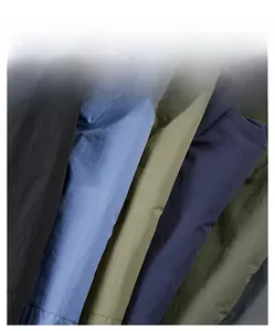 Texture detail of water-resistant nylon fabric in various colors for outdoor jackets
