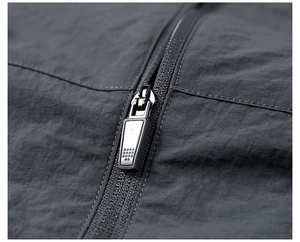 Macro shot of durable matte black zipper on dark gray water-resistant windbreaker